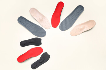 Many orthopedic insoles on white background
