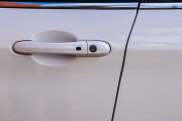 Detail of a car door handle. Focuses on the design and usability elements of modern vehicles....