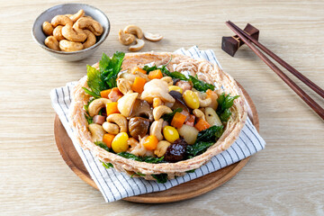 Stir fried mixed Chinese fruits and nuts on a wooden table