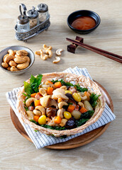 Stir fried mixed Chinese fruits and nuts on a wooden table