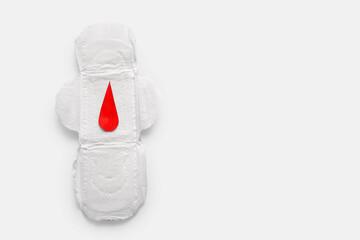 Menstrual pad with paper blood drop on white background