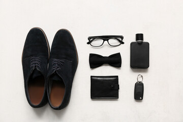 Set of male accessories with eyeglasses, bow tie and wallet on white background. Top view