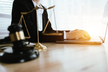 Lawyer sitting at desk in modern office reviewing and signing legal documents related to finance, equity and contractual agreements in business law.