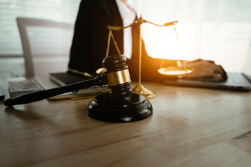 Lawyer sitting at desk in modern office reviewing and signing legal documents related to finance, equity and contractual agreements in business law.