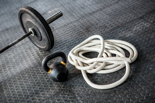 Fototapeta Barbell and kettlebell with rope
