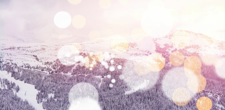 Fototapeta Snowcapped mountains with bokeh in foreground