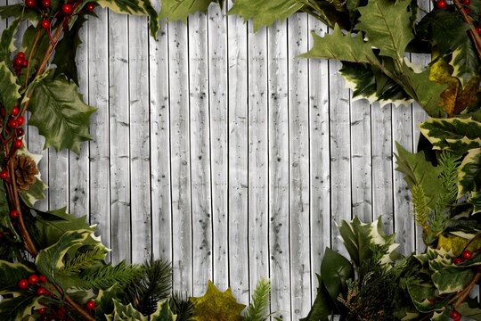 Holly twigs over wooden planks