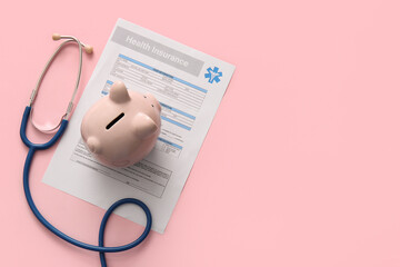 Health insurance form, piggy bank and stethoscope on pink background