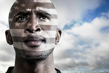 Flat design portrait is showing shaved head under stars stripes overlay against gray to blue sky