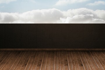 Empty wooden deck floor is showing flat design with dark textured wall panels and cloudy sky