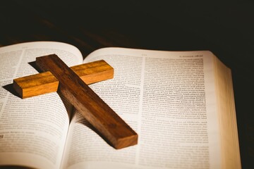 Wooden cross kept on bible
