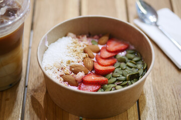 Healthy breakfast bowl with fruits and nuts in a cafe
