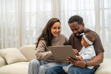 African love family happy time at home, father showing baby a tablet with cartoons for early childhood learning and development, mother smiling engaging in digital parenting and interactive education