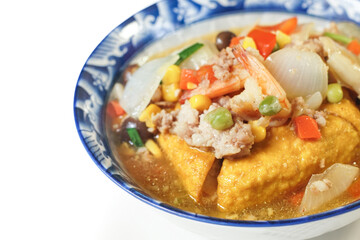Fried tofu topped with minced pork, shrimp, and nutritious vegetables. An easy to make ancient Chinese dish. Asian food on white background.