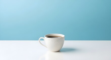 White Coffee Cup on White Table Against Blue Background