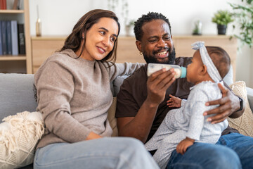 African father lovingly feeding baby with a milk bottle, nurturing care and bonding, providing essential nutrition and protein for healthy growth, black family parenting, warmth, trust and affection