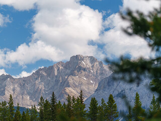 Rocky mountain peak in Peter Lougheed Provincial Park, Alberta. Dense evergreen forest below and...