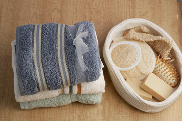 Towels and spa essentials arranged on a wooden surface