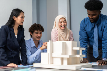 Architects engineers collaborating on building design project in modern office, diverse team of...