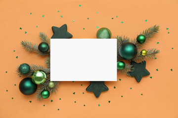 Blank card, Christmas balls, confetti and fir branches on orange background