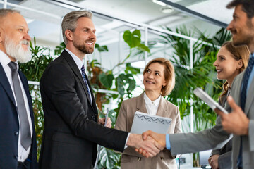 Businessmen shaking hands during a meeting.