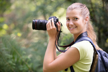 young woman with camera outdoors portrait