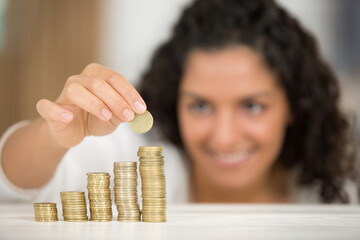 picture of woman stacking up coins