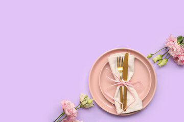 Stylish table setting with beautiful eustoma flowers on lilac background