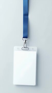 A blank name badge mockup with blue lanyard placed on a minimal gray background. Concept of professional networking and corporate identity at formal business events.

