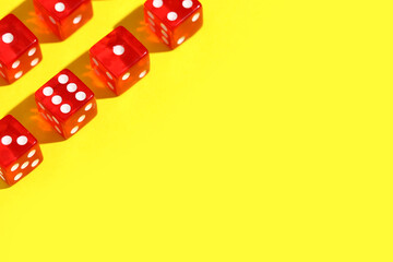 Red game dices on yellow background