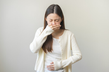 Unhappy pregnant asian young woman, pain girl suffering from nausea, having vomit feeling sick...