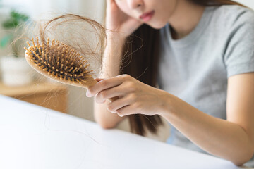 Problem hair, stressed beautiful asian young woman, girl hand holding comb show hairbrush with hair...