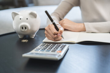 Saving money wealth concept, asian young business woman hand write management budget for saving...
