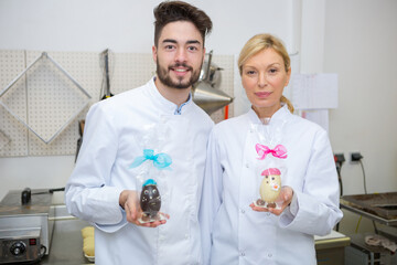 portrait of chocolatiers holding chocolate eggs