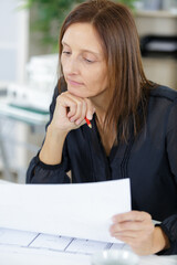 woman architect looking at plans