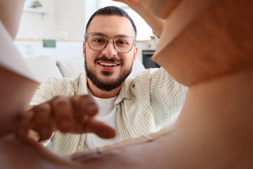 Young man with paper bag at home, view from inside. Food delivery service