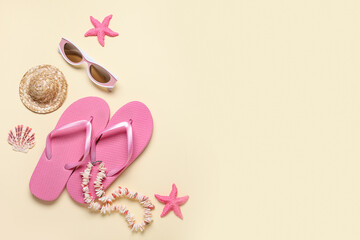 Composition with sunglasses, necklace, decorative hat and flip-flops on beige background