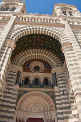 Domes and towers of the Marseille Cathedral of Sainte-Marie-Majeure in the La Joliette district, neo-Byzantine architecture under a blue sky