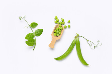 Wooden scoop with fresh green peas and leaves on grey background