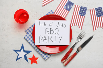USA flags, paper sheet with text 4TH OF JULY BBQ PARTY and dinnerware on white grunge background....