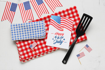 USA flags, greeting card with text HAPPY 4TH OF JULY and barbecue spatula on white grunge...