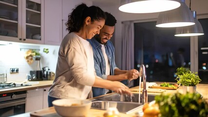Happy Couple Washing Dishes Together in Modern Kitchen at Night, Smiling and Enjoying Domestic Life - Powered by Adobe