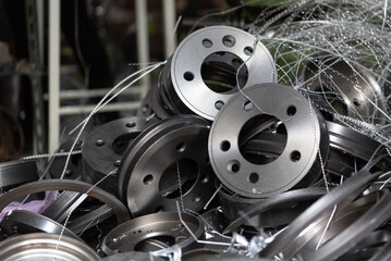 Car mechanic or serviceman disassembly and checking a disc brake and asbestos brake pads for fix...