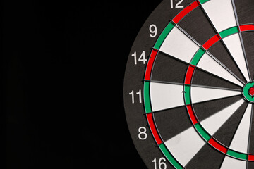 Board for playing darts on dark background, closeup