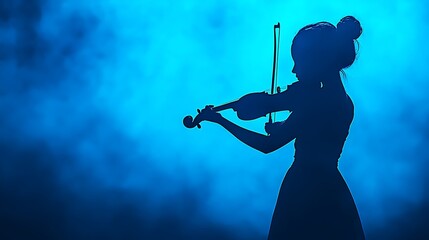 Fototapeta premium Silhouette of a Female Violinist Playing in Dramatic Blue Lighting with Smoke Background
