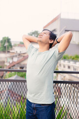 Man Relaxing Outdoors on Balcony, Looking Upwards and Appreciating Sky, Daydreaming at Ease,