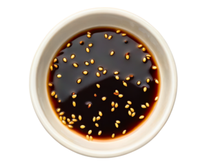 Small white bowl filled with dark soy sauce topped with sesame seeds on a transparent background