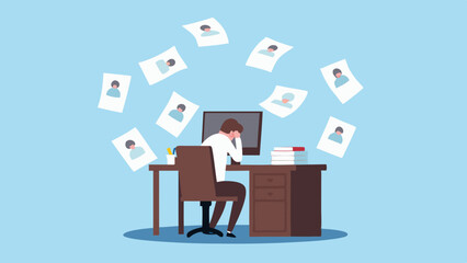 Overwhelmed businessman sitting at desk with falling resumes and computer screen