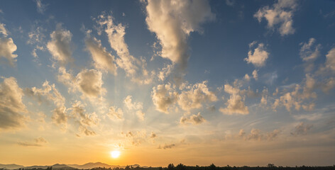 Sunset sky clouds in the evening summer with Orange, Yellow sunlight in Golden hour or morning sunrise, Horizon sky nature background