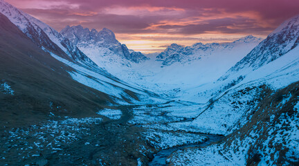 The mountain view of alpine as snow-capped mount peaks in Winter mountains